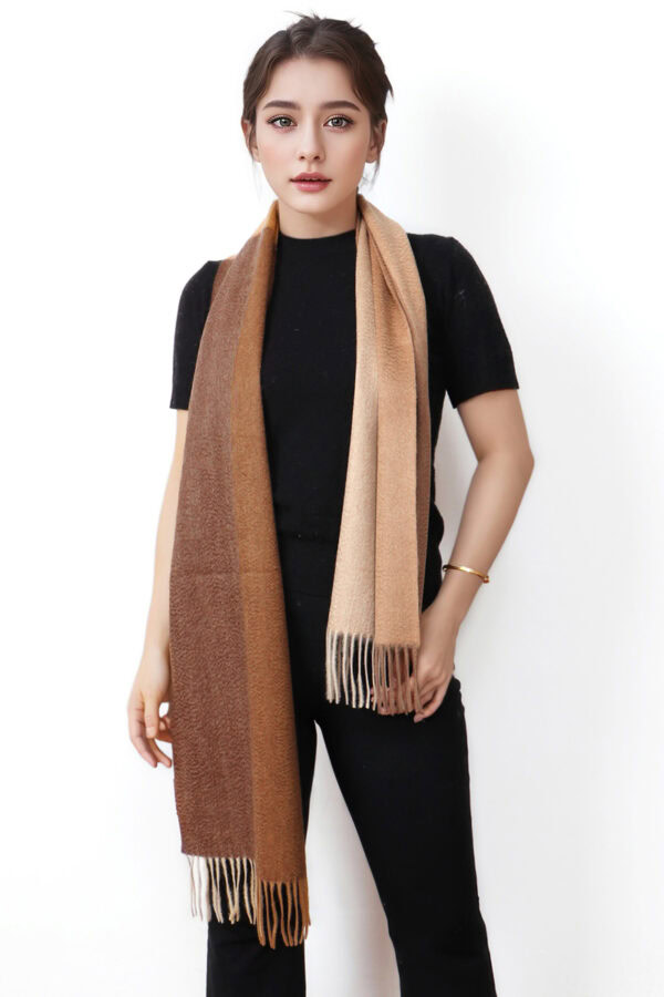 A woman wearing a brown and coffee plaid cashmere scarf